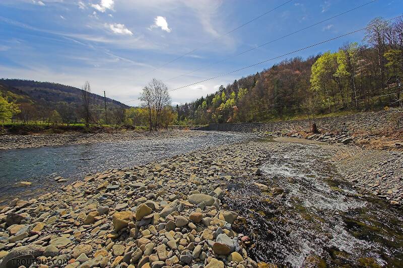 A swift tributary of a Catskill trout stream slides down its own high delta of boulders and cobble.

From the Beaverkill River, Horton Bridge Pool in New York