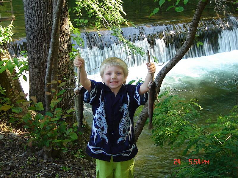 Little Joe and his first trout, caught in Gatlinburg TN.